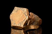 Ca. 1200 AD.
A gold ring of flat section hoop, expanding gracefully at the shoulders, is embellished with intricate incised designs that reflect the e...