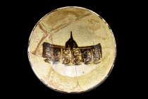 Ca 13th century AD.
A ceramic bowl of hemispherical shape rising from an unglazed ring foot. The glazed interior is decorated with stylised motifs pai...