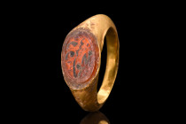 Intaglio - ca. 1600-1700 AD; Ring ca. 400-600 AD.
A gold ring adorned with a carnelian intaglio featuring masterful calligraphy. This exquisite piece ...