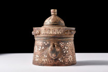 Ca. 1100-1200 AD.
A bronze inkwell with its distinctive drum-shaped body, gently flaring to its flat base. The walls are adorned with silver inlaid de...