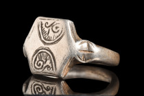 Ca. 1000 AD.
A silver finger ring of a solid band, elegantly hewn, envelops the finger with an understated grace. The centrepiece of this artefact res...