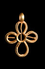 Ca. 600-800 AD.
A gold cruciform pendant of an openwork design, featuring four arms with beaded edges and rounded finials. The cross has a long and ri...