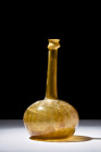 Ca. 1100-1200 AD.
A glass sprinkler flask, resplendent in a radiant gold-yellow hue, this vessel unveils an apple-shaped lower body that gracefully co...