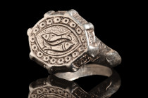 Ca. 10th-13th century AD.
A silver finger ring with a rather slender hoop that delicately widens to gracefully support a prominent bezel. The shoulder...