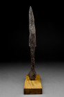 Ca. 13th-15th century AD.
An iron short knife blade with rivetted tang and integral forged round pommel. The tang may have been inlaid with wood or bo...