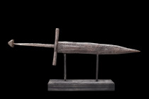 Ca. 1200-1300 AD.
An interesting iron dagger of a quite lethal form. Blade sharpened on each edge, Cross hilt, thin handle once supporting a wooden gr...