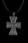 Ca. 600-800 AD.
A bronze cross pendant with flaring terminals and concentric circles motif at the junction and each arm. The five wounds of Christ mo...