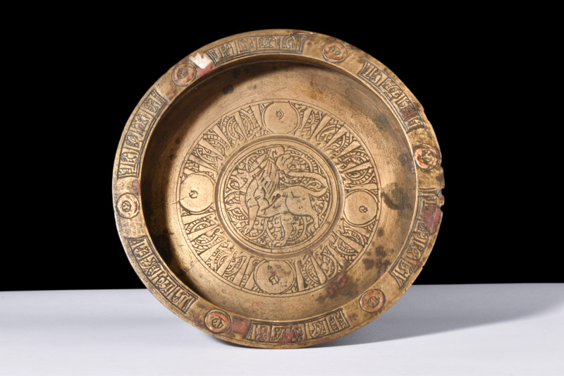 Ca. 1100-1200 AD.
A copper inlaid brass dish with a broad and flat base, accompa...