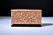 Ca. 1100-1200 AD.
A rectangular-shaped terracotta tile adorned with intricate details. The upper face is graced by a symphony of design, with delicate...