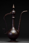 Ca. 1500 AD.
A beautiful bronze ewer of typical piriform shape with a curved handle, and a long spout. The vessel rises from a flared circular base, w...