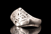 Viking Era, ca. 900-1100 AD.
A silver finger ring with a flat-section round hoop that gently widens to form a lozenge-shaped bezel decorated with the ...