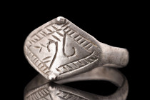 Viking Era, ca. 900-1100 AD.
A finger ring crafted from sterling silver, boasting a flat-sectioned round hoop that gracefully expands to create a capt...
