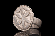 Ca. 1100-1400 AD.
A silver ring featuring a broad, flat-section shank that provides both strength and comfort during wear. The applied large bezel, ad...