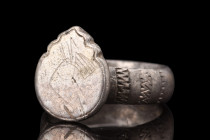 Ca. 1100-1400 AD.
A silver ring featuring a broad, flat-section shank, providing both stability and comfort when worn. The shoulders of the ring are a...