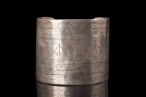 Ca. 1400-1500 AD.
A silver bracelet, crafted with exceptional artistry and precision. It embodies a distinctive design characterized by its broad, ope...