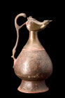 Ca. 1100-1200 AD.
A bronze ewer displaying an inverted piriform body gracefully balances upon a flared foot, exhibiting an exquisite fusion of form an...