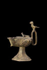Ca. 1100-1200 AD.
A bronze oil lamp with its form both functional and aesthetically pleasing, featuring a flaring, concave foot that provides stabilit...