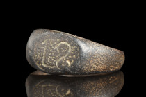 Ca. 1100-1400 AD.
A bronze finger ring with an air of reverent elegance. Its form, an ode to harmony, commences with a round hoop that envelops the fi...