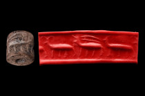 Ca. 3000 BC.
Cylinder seal of brown stone. Frieze of three walking quadrupeds, something over the back of one. Condition good. Accompanied by a signed...