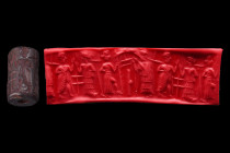 Old Syrian, ca. early 2nd millennium BC.
A Levantine hematite cylinder seal. It depicts deities and a royal hero with schematic ornaments in the field...
