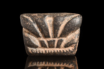 Ca. 2nd millennium BC.
A stone stamp seal with a rhomboid silhouette, commands attention with its geometric elegance. The meticulously engraved scene ...