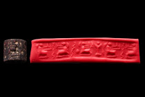 Ca. 3000-2900 BC.
A black stone cylinder seal, Mesopotamia or Syria. Three squatting women with hands raised, two snakes, one standard, two fillings s...