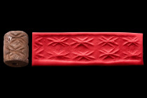 Ca. 3000 BC.
A brown stone cylinder seal. A frieze of three pairs of a single motif, probably a stylized water creature. Cracked, otherwise good condi...