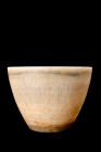Ca. 2nd millennium BC.
A stone bowl, notable for its tall and gracefully flaring form, emerges from a flat circular base with an air of refined elegan...