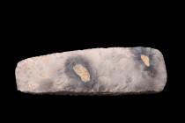 Ca. 8000-6000 BC.
A neolithic flint axe, crafted through the process of knapping, displays a distinctively greyish hue, possessing an inherent eleganc...
