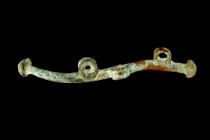 Ca. 2nd-1st millennium BC.
A bronze cheek piece, composed of a round-section rod boasting an S-shaped profile, culminating in rounded cap heads at eit...