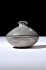 Ca. 200-300 AD.
A schist box comprises a rounded bowl, carefully designed with a flange that graciously accommodates a lid. The lid, with its alluring...