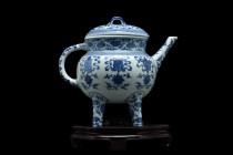 .
A white and blue porcelain ewer with a squat body resting on four cylindrical legs. The finely decorated main body consists of a broad and deep cont...