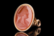 Ca. 1800-1900 AD.
A gold seal with a carnelian intaglio with an engraved profile portrait of a Roman empress, meticulously crafted to capture her like...