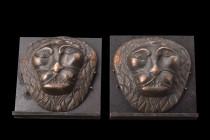Ca. 1700-1800 AD or earlier.
A pair of bronze mounts depicting lion heads showed en face. Each lion head exhibits distinct characteristics, such as al...