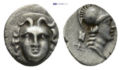 Pisidia. Selge circa 350-300 BC. Obol AR 0.61 Gr. 10mm.
Gorgoneion 
Rev. Head of Athena to right, wearing crested Attic helmet; behind, astragalos.