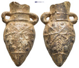 Amphora-Shaped Pilgrim's Ampulla. A lead ampulla in the shape of an amphora with wide neck, small handles to the shoulder, conical body tapering to a ...
