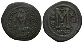 Justinian I, AD 527-565. AE, Follis. 21.89 g. 41.26 mm. Nicomedia.
Obv: DNIVSTINI-ANVS PPAVC. Frontal bust of Justinian I wearing helmet with plume, ...