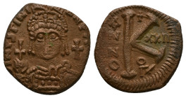 Justinian I, AD 527-565. AE, Half Follis. 9.75 g. 27.53 mm. Theoupolis (Antioch).
Obv: DN IVSTINI[ANVS PP AVG]. Helmeted, cuirassed bust facing, holdi...