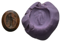 Greco-Roman intaglio gemstone with standing Victory (AD 2nd–3rd centuries)
A carnelian intaglio with a draped Victory writing on an oval shield held ...
