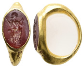 Roman gold finger-ring with sard in bezel (AD 1st–2nd centuries).
Gold finger-ring, hoop elliptical, expanding at shoulders. Oval bezel with sard inta...