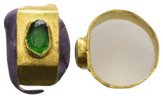 Greco-Roman gold finger-ring (AD 3rd century)
Gold finger-ring; hoop formed of flat gold band; raised oval setting with green glass paste in the cent...