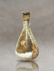 Presenting an exceptional ancient Roman dropper flask, crafted from pale glass using the technique of mould blowing. This mesmerizing artifact feature...