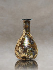 Immerse yourself in the ancient Roman world with this remarkable blown glass artifact, meticulously crafted from delicate pale glass. Its small pirifo...