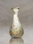 Discover the beauty of Roman blown glass with this exquisite artifact. Skillfully crafted from delicate pale glass, it features a small piriform body ...