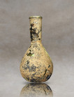 Immerse yourself in the beauty of an ancient Roman bottle, crafted from pale green glass. This exquisite artifact features a captivating combination o...