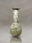An ancient Roman glass flask with a tall cylindrical neck, wide flat rim, and a globular body resting on a concave base. The surface exhibits iridesce...