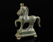 A FINE ROMAN BRONZE STATUETTE OF A STRIDING HORSE Circa 2nd-3rd century AD. The right foreleg raised, the head slightly turned and angled. Cast in one...