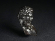 A ROMAN BRONZE ATTACHMENT WITH A BUST OF HERCULES Circa 1st-3rd century AD. Hercules is depicted with curly hair, a long curly beard, and bare chest. ...