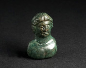 A ROMAN BRONZE APPLIQUE BUST OF A YOUTH Circa 2nd-3rd century AD. The hair parted in the centre; with bare chest. H 34 mm

Ex private collection, ac...