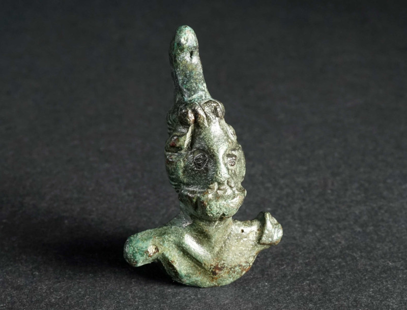 A ROMAN BRONZE ATTACHMENT DEPICTING A BEARDED GOD Circa 2nd-3rd century AD. Smal...